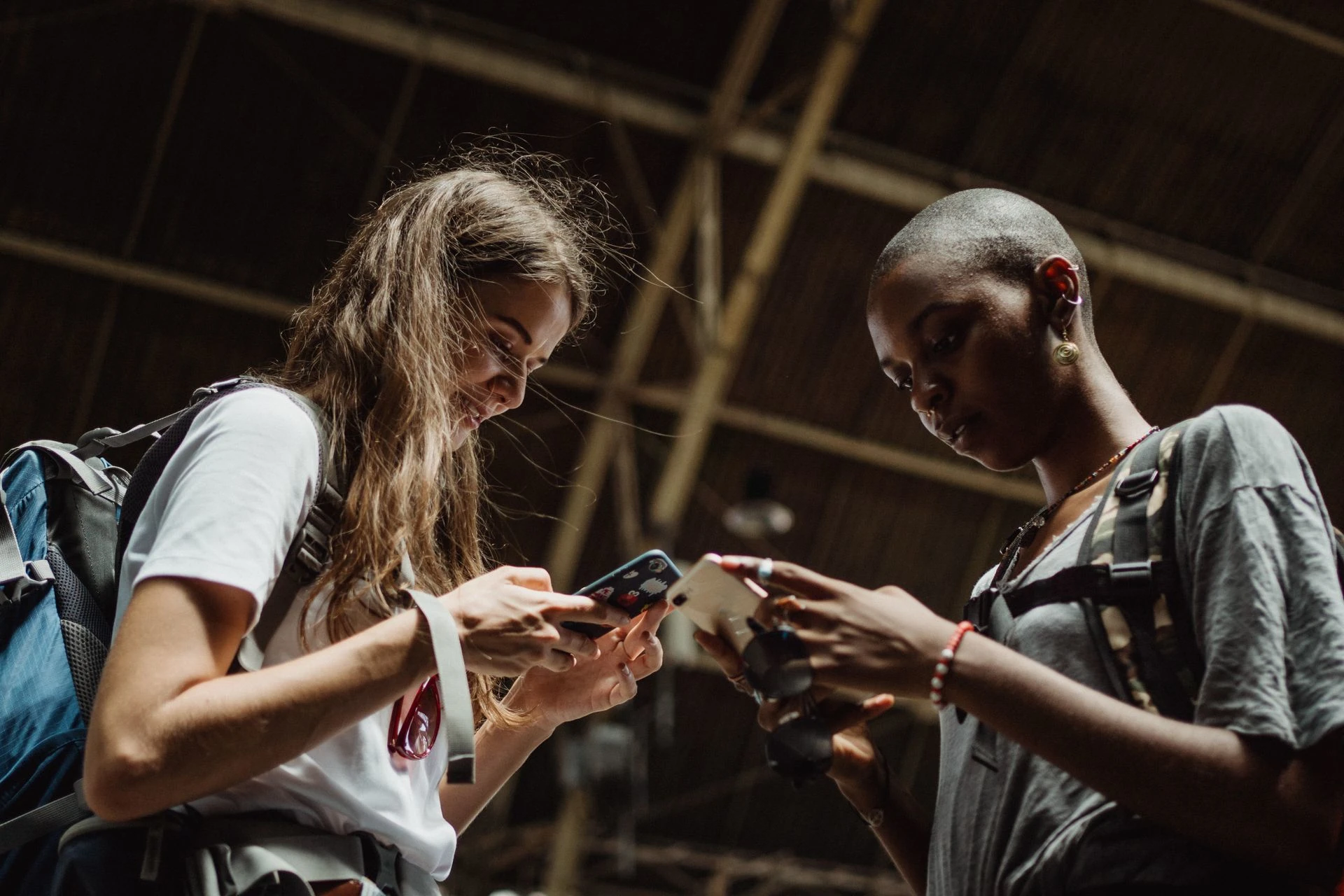 Two people looking at what's on their own phones.